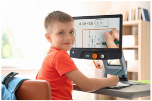 Child using assistive technology to do school work.