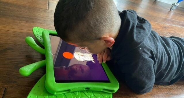 Zane watching the YouTube channel on an iPad