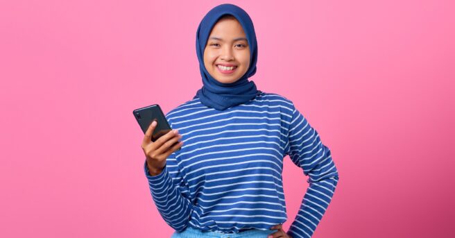 young adult smiling confidently at the camera