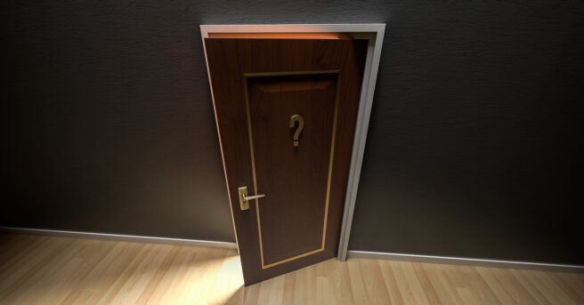 A cracked door with a question mark on it.