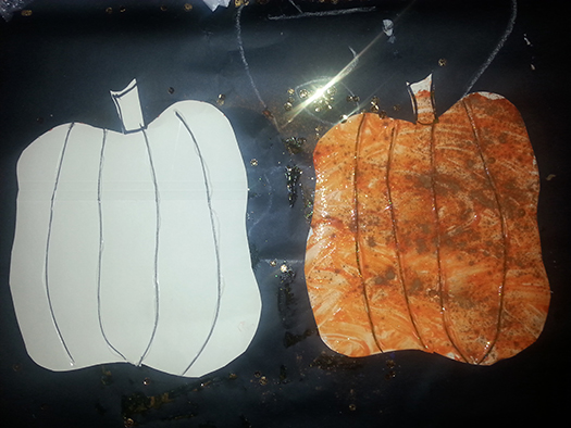 a before-and-after picture of a pumpkin cutout, decorated with finger paint and spices