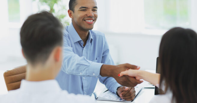 Person shaking hands with a couple